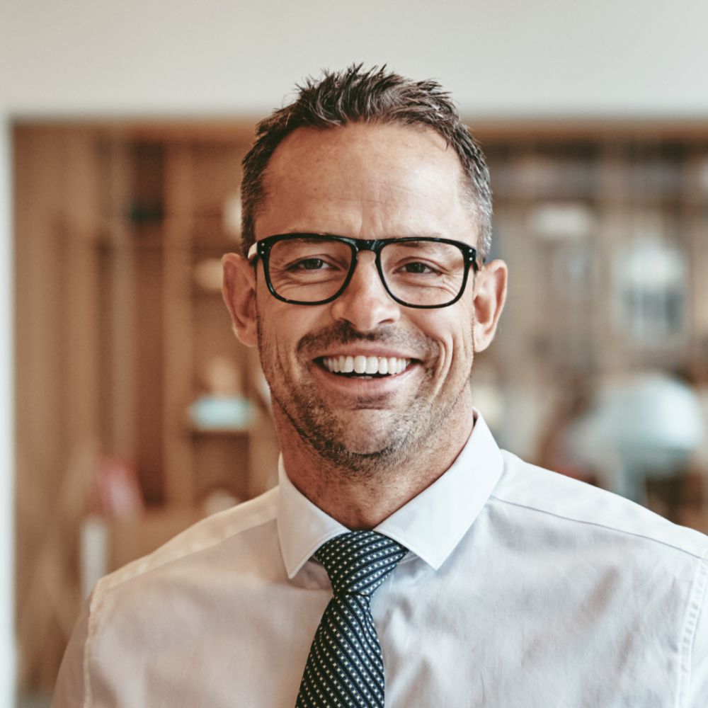 Testimonials smiling mature businessman standing alone in an of y89vgbd 1 1.jpg